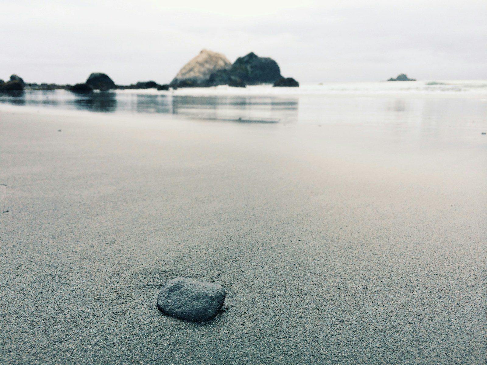 A lone pebble on the shoreline.